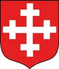Grafika przedstawia herb gminy Dobrzyca - biały krzyż na czerwonym tle